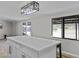 Open kitchen with a large island, modern lighting, and view to the exterior yard at 13050 N Breeze Way, Maricopa, AZ 85139