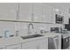 Kitchen showcasing white cabinetry, stainless steel appliances, and quartz countertops at 13050 N Breeze Way, Maricopa, AZ 85139