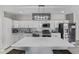Newly remodeled kitchen features stainless appliances, a large island, and sleek white cabinets for a modern feel at 13050 N Breeze Way, Maricopa, AZ 85139