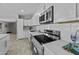 Bright kitchen features white cabinets, countertops and new stainless steel appliances still covered at 13050 N Breeze Way, Maricopa, AZ 85139