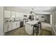 Modern kitchen features stainless appliances, an island with seating, and white cabinetry for a bright, stylish design at 13050 N Breeze Way, Maricopa, AZ 85139