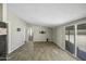 Open living space with tile floors, neutral paint and a slider to the backyard at 13050 N Breeze Way, Maricopa, AZ 85139