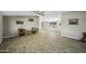 Inviting living room with light gray walls, tile floors, ceiling fan, and ample natural light at 13050 N Breeze Way, Maricopa, AZ 85139