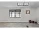 Neutral living room with modern lighting and views of the desert landscape at 13050 N Breeze Way, Maricopa, AZ 85139