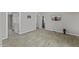 Open-concept room featuring modern flooring, doorways and neutral paint at 13050 N Breeze Way, Maricopa, AZ 85139
