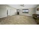 Spacious living room with wood-look tile floors, ceiling fan, and ample natural light at 13050 N Breeze Way, Maricopa, AZ 85139