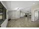 Open-concept living space with wood-look tile floors and lots of windows, offering abundant natural light at 13050 N Breeze Way, Maricopa, AZ 85139