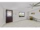 Cozy living room featuring wood-look floors, door with decorative glass, and a ceiling fan at 13050 N Breeze Way, Maricopa, AZ 85139