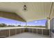 Covered patio view of the expansive, sandy and fenced yard and mountain backdrop at 13050 N Breeze Way, Maricopa, AZ 85139