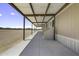 Covered patio running the length of the home with concrete floors and metal awning at 13050 N Breeze Way, Maricopa, AZ 85139