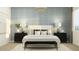 Relaxing bedroom featuring a stylish bed, textured blue wallpaper, and a decorative chandelier at 14949 W Cottontail Ln, Surprise, AZ 85387