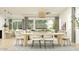 Open-concept dining area with natural light, seating for six, and stylish decor at 14949 W Cottontail Ln, Surprise, AZ 85387