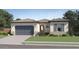 Charming single-story home with tile roof, lush green lawn, and two-car garage at 14949 W Cottontail Ln, Surprise, AZ 85387