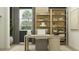 Inviting home office featuring built-in shelves, desk, comfortable seating, and stylish decor elements at 14949 W Cottontail Ln, Surprise, AZ 85387