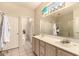 Bathroom featuring double sinks, a neutral color scheme, and tiled floors at 15874 W Wildflower Dr, Surprise, AZ 85374
