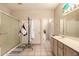 Bathroom with tiled floors, single sink vanity, shower, and toilet at 15874 W Wildflower Dr, Surprise, AZ 85374