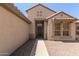Inviting entryway featuring a secure screen door and neutral stucco, blending security and style at 15874 W Wildflower Dr, Surprise, AZ 85374