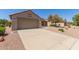 Well-kept home with a two-car garage, a long driveway, and desert landscaping for low maintenance at 15874 W Wildflower Dr, Surprise, AZ 85374