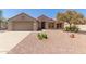 Charming single-story home featuring a desert-landscaped front yard, two-car garage, and a well-maintained facade at 15874 W Wildflower Dr, Surprise, AZ 85374