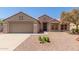 Charming home with a neutral exterior, well-maintained landscaping, and an attached two-car garage at 15874 W Wildflower Dr, Surprise, AZ 85374