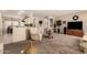 Inviting living room featuring neutral walls and carpet, seamlessly connecting to the kitchen and dining area at 15874 W Wildflower Dr, Surprise, AZ 85374