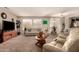 Comfortable living room with carpeted floors, featuring sofas and a unique wooden coffee table at 15874 W Wildflower Dr, Surprise, AZ 85374