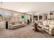 Spacious living room with plush carpet, neutral walls, and large windows providing ample natural light at 15874 W Wildflower Dr, Surprise, AZ 85374