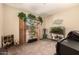 Flex room with an aquarium, artificial plants, and natural light from the enclosed patio at 15874 W Wildflower Dr, Surprise, AZ 85374