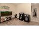 Additional room with carpet, aquarium, decorative fish art, and speakers at 15874 W Wildflower Dr, Surprise, AZ 85374