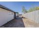 Backyard with small covered patio next to a wooden fence at 1616 E Pecan Rd, Phoenix, AZ 85040