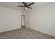 Carpeted bedroom features a ceiling fan and an open doorway to another room at 1616 E Pecan Rd, Phoenix, AZ 85040