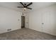 Bedroom with neutral carpet, ceiling fan, closet, and a door, providing functional living space at 1616 E Pecan Rd, Phoenix, AZ 85040