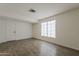 An inviting bedroom features wood-look tile flooring, neutral walls, and ample natural light, offering a serene retreat at 1616 E Pecan Rd, Phoenix, AZ 85040
