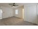 Spacious bedroom features a ceiling fan, carpet, a closet, and a connected room at 1616 E Pecan Rd, Phoenix, AZ 85040