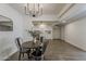 Dining area with a table and chandelier, connecting to a kitchen, creates an inviting open-concept living space at 1616 E Pecan Rd, Phoenix, AZ 85040