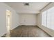 Bright living room featuring wood-look tile flooring and a large window for natural light at 1616 E Pecan Rd, Phoenix, AZ 85040