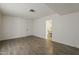 Minimalist living room boasts wood-look tile floors and a glimpse into the dining area at 1616 E Pecan Rd, Phoenix, AZ 85040