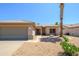 Charming single-story home with a two-car garage, desert landscaping and a palm tree in the front yard at 16354 W Labyrinth Ln, Surprise, AZ 85374