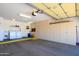 Spacious garage with abundant storage cabinets, laundry area, and epoxy flooring at 16354 W Labyrinth Ln, Surprise, AZ 85374