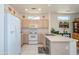 Well-lit kitchen with white appliances, light wood cabinets, and tile flooring at 16354 W Labyrinth Ln, Surprise, AZ 85374