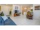 Spacious living area features an open layout, seamlessly connecting the living room, dining area, and kitchen with tile flooring at 16354 W Labyrinth Ln, Surprise, AZ 85374