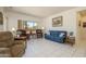 Inviting living room features comfortable seating, tile floors, and large windows that provide ample natural light at 16354 W Labyrinth Ln, Surprise, AZ 85374