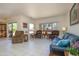 Spacious living room filled with comfortable seating arrangements, neutral tile flooring, and ample natural light at 16354 W Labyrinth Ln, Surprise, AZ 85374