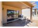 A covered patio provides a perfect space for outdoor dining and relaxing at 16354 W Labyrinth Ln, Surprise, AZ 85374