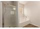 Bathroom showcasing a glass shower and a large soaking tub at 17493 N Costa Brava Ave, Maricopa, AZ 85139