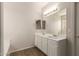 Clean bathroom with double sinks, a large mirror, and white cabinets at 17493 N Costa Brava Ave, Maricopa, AZ 85139