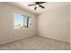 Inviting carpeted bedroom with a ceiling fan and a window overlooking the landscape at 17493 N Costa Brava Ave, Maricopa, AZ 85139