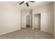 Cozy bedroom featuring neutral carpeting, ceiling fan, and a closet with sliding doors at 17493 N Costa Brava Ave, Maricopa, AZ 85139