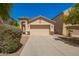 Charming single-story home featuring a two-car garage, desert landscaping, and a welcoming facade at 17493 N Costa Brava Ave, Maricopa, AZ 85139