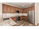 Well-equipped kitchen showcasing stainless steel appliances, granite countertops, and dark wood cabinets at 17493 N Costa Brava Ave, Maricopa, AZ 85139